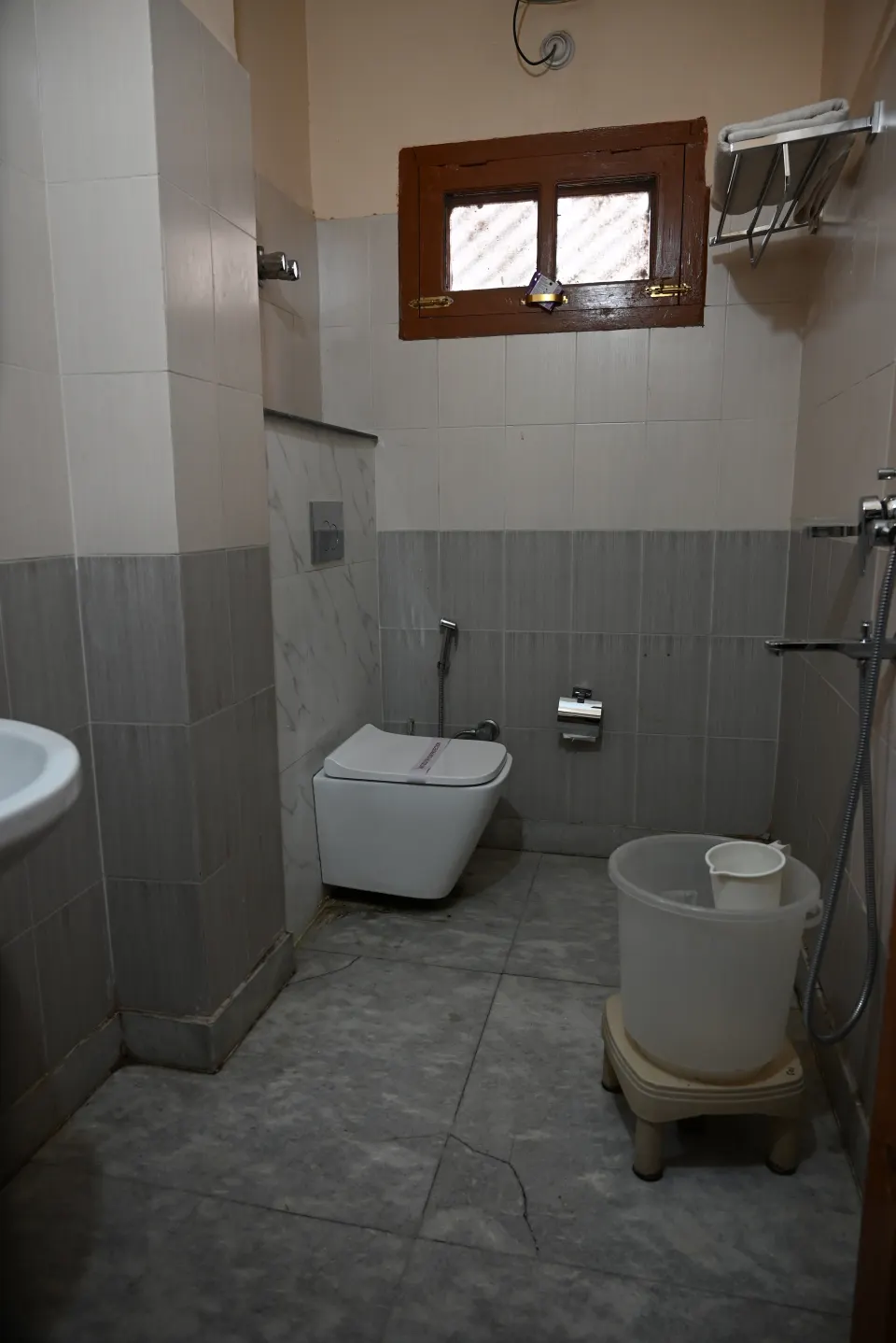 Clean tiled bathroom with western toilet