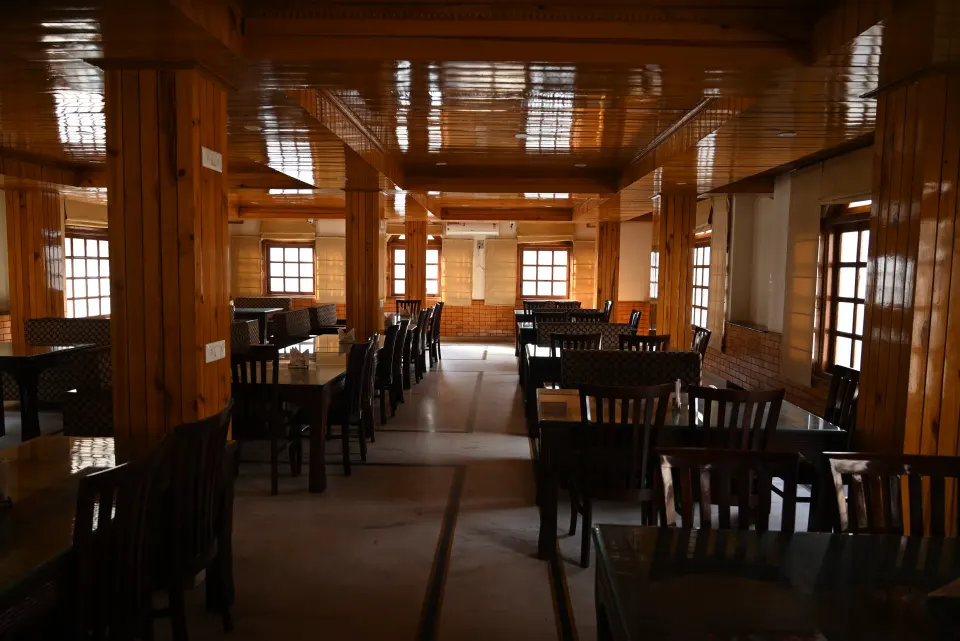 Restaurant hall with large windows and wooden pillars